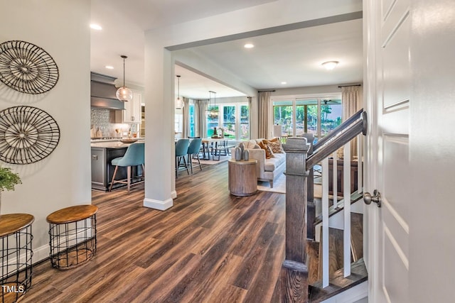 living area featuring baseboards, recessed lighting, stairs, and dark wood-type flooring