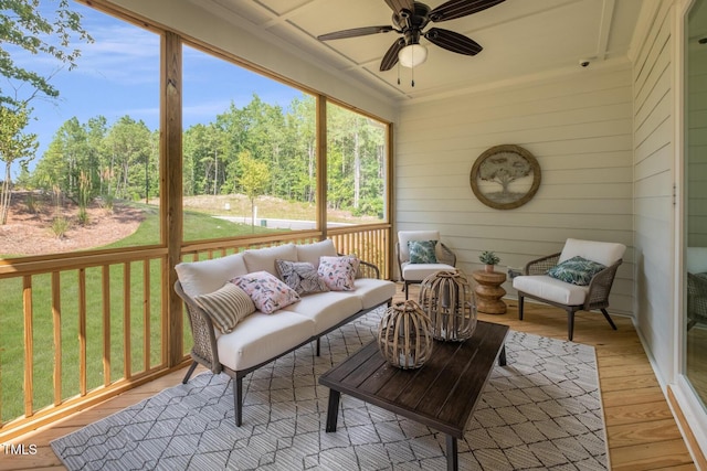 sunroom featuring an outdoor living space and a ceiling fan