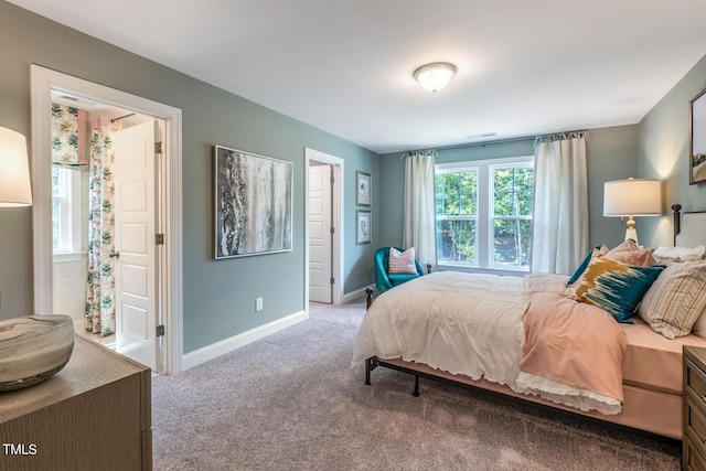 bedroom with carpet and baseboards