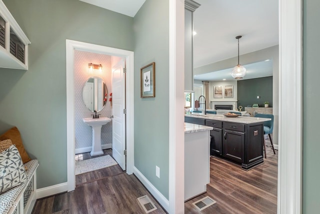 interior space with visible vents, wood finished floors, and baseboards