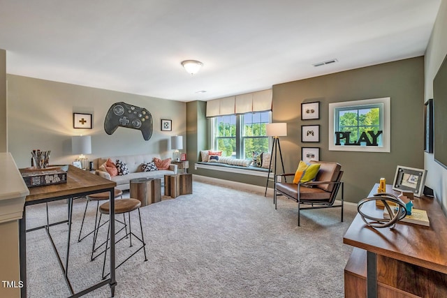 carpeted living room featuring visible vents and baseboards