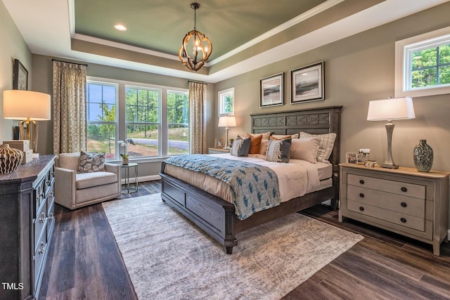 bedroom with recessed lighting, a notable chandelier, a raised ceiling, crown molding, and dark wood finished floors