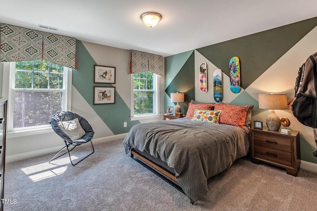 carpeted bedroom with visible vents and baseboards