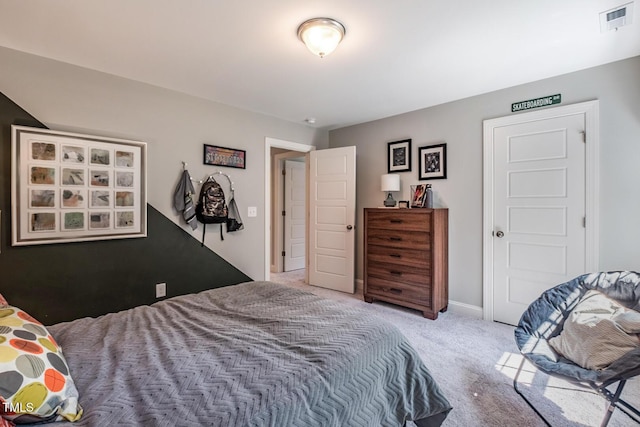 bedroom featuring baseboards, visible vents, and light carpet