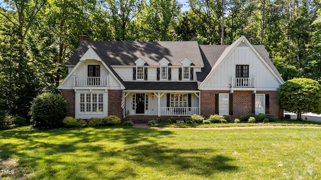 2409 Beechview Ct, Raleigh, NC 27615 - view of front of home with brick siding, a porch, board and batten siding, a front lawn, and a chimney