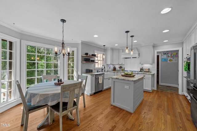 2409 Beechview Ct, Raleigh, NC 27615 - kitchen featuring a kitchen island, open shelves, a sink, stainless steel appliances, and ornamental molding