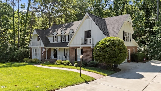 2409 Beechview Ct, Raleigh, NC 27615 - view of front of home featuring a porch, brick siding, board and batten siding, driveway, and roof with shingles