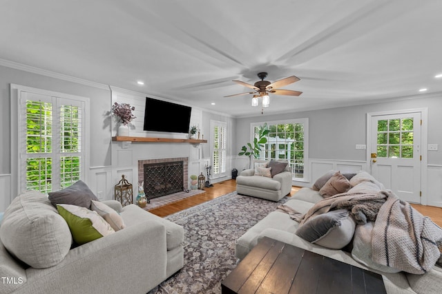 2409 Beechview Ct, Raleigh, NC 27615 - living room featuring crown molding, healthy amount of natural light, recessed lighting, a brick fireplace, and ceiling fan