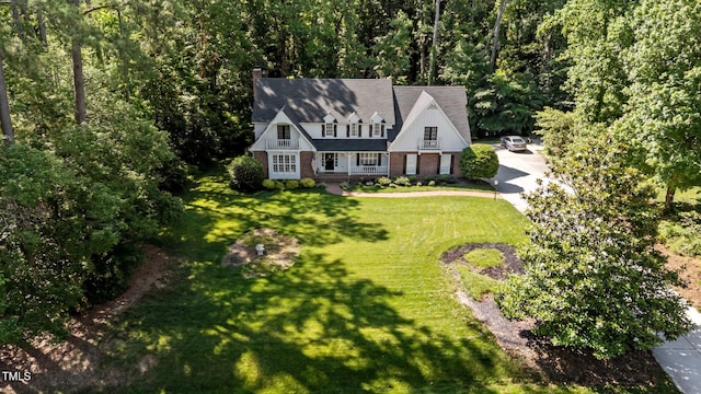 2409 Beechview Ct, Raleigh, NC 27615 - view of front facade featuring a front yard, concrete driveway, brick siding, and a chimney