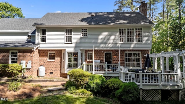 2409 Beechview Ct, Raleigh, NC 27615 - back of house featuring brick siding, a chimney, a wooden deck, and roof with shingles