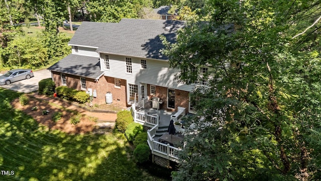 2409 Beechview Ct, Raleigh, NC 27615 - rear view of house featuring brick siding, a shingled roof, and a wooden deck
