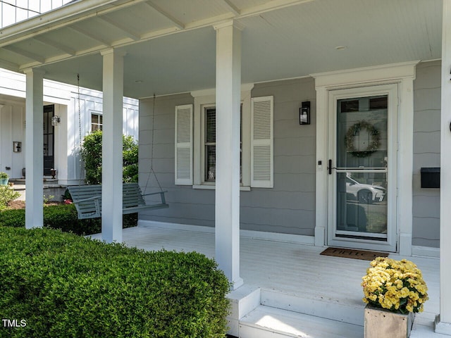 view of exterior entry with a porch