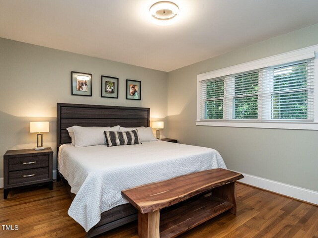 bedroom with baseboards and wood finished floors