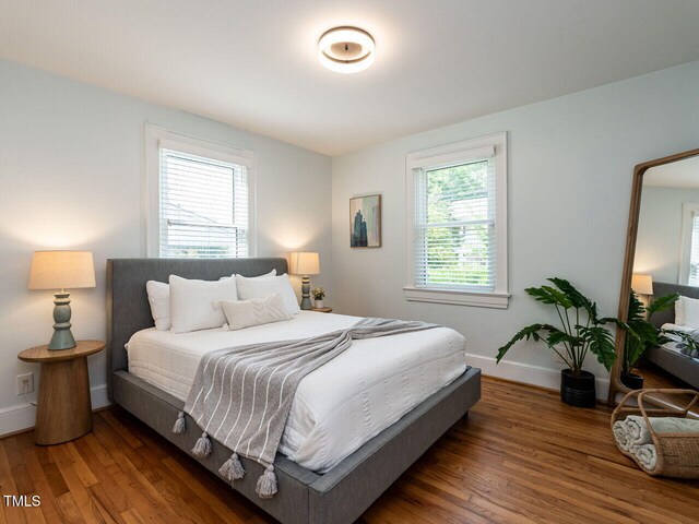 bedroom featuring baseboards and wood finished floors