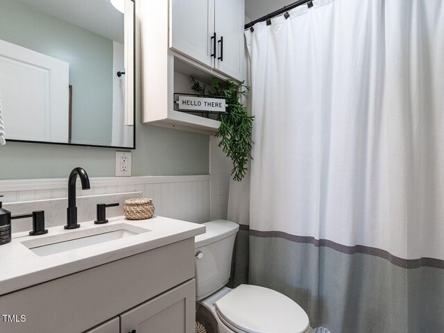bathroom featuring vanity and toilet