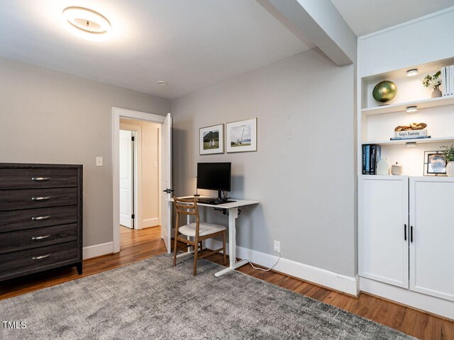 office area featuring baseboards and wood finished floors