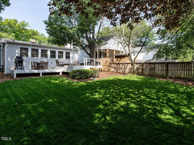view of yard featuring fence and a deck