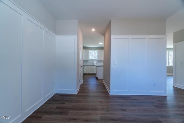 corridor with recessed lighting and dark wood finished floors