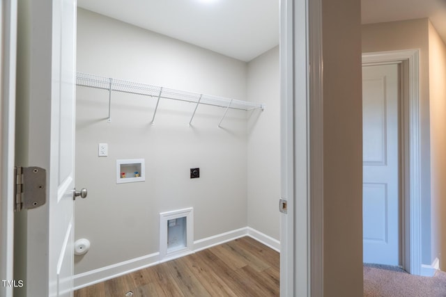 clothes washing area featuring wood finished floors, electric dryer hookup, baseboards, laundry area, and washer hookup