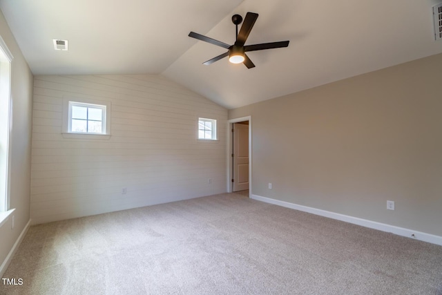 empty room with ceiling fan, a healthy amount of sunlight, carpet flooring, and visible vents