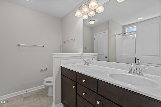 full bathroom featuring baseboards, a stall shower, toilet, and a sink