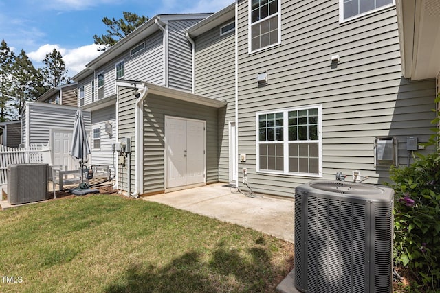 back of house with a yard, central AC, a patio area, and fence