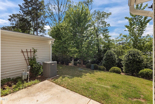 view of yard with central AC and a patio area