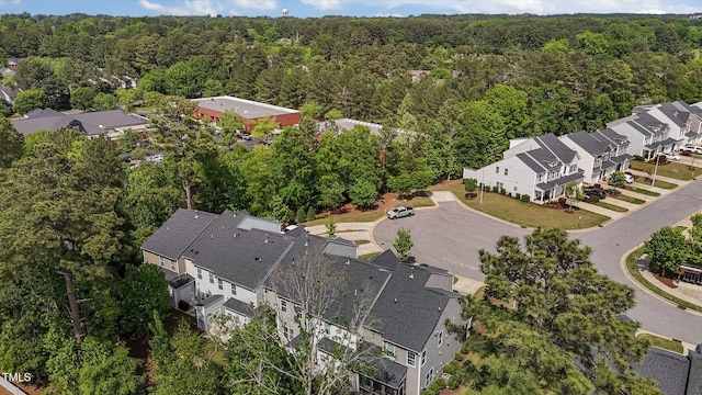 aerial view featuring a wooded view and a residential view