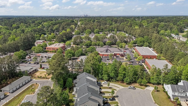 bird's eye view featuring a residential view and a wooded view