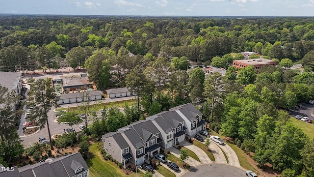 birds eye view of property with a view of trees
