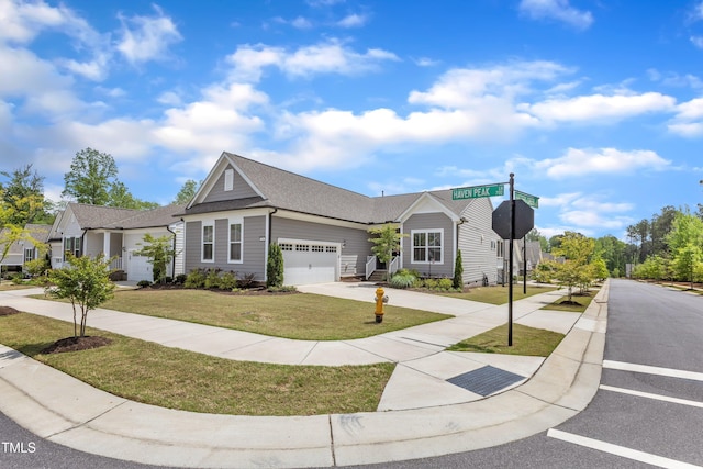 704 Haven Peak Ln, Wake Forest, NC 27587 - view of front of house with a garage, a front lawn, driveway, and roof with shingles