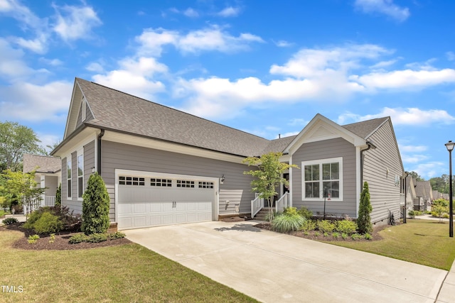 704 Haven Peak Ln, Wake Forest, NC 27587 - view of front of home with driveway, an attached garage, a front lawn, and a shingled roof