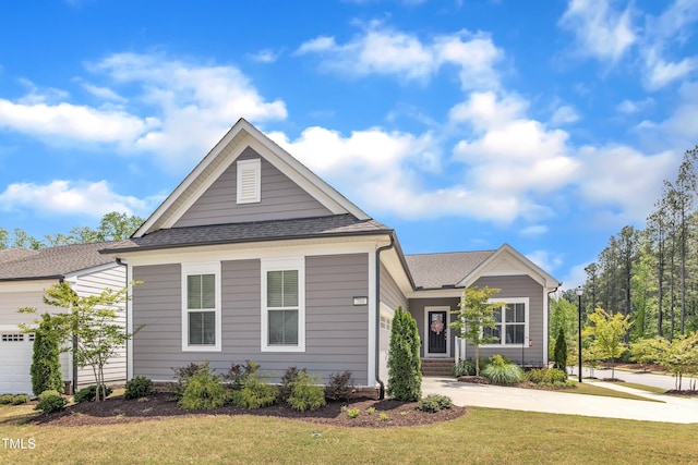 704 Haven Peak Ln, Wake Forest, NC 27587 - view of front facade with a front lawn, a garage, driveway, and roof with shingles