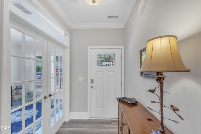 704 Haven Peak Ln, Wake Forest, NC 27587 - foyer featuring light wood-type flooring, plenty of natural light, ornamental molding, and french doors