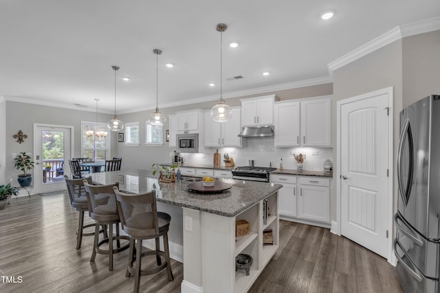 704 Haven Peak Ln, Wake Forest, NC 27587 - kitchen with stainless steel appliances, white cabinets, under cabinet range hood, a breakfast bar area, and dark wood-style floors
