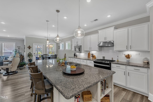 704 Haven Peak Ln, Wake Forest, NC 27587 - kitchen featuring under cabinet range hood, open shelves, white cabinetry, black gas range, and backsplash