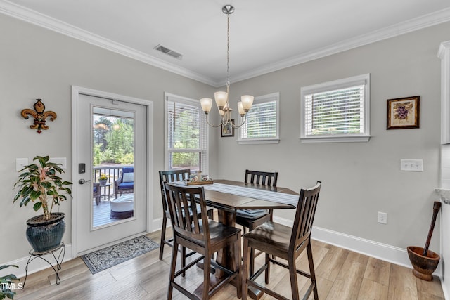704 Haven Peak Ln, Wake Forest, NC 27587 - dining room with light wood finished floors, a chandelier, and ornamental molding