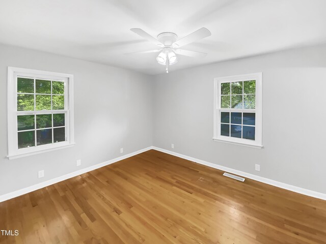 3504 Crofton Ct, Raleigh, NC 27604 - empty room featuring baseboards, wood finished floors, visible vents, and ceiling fan