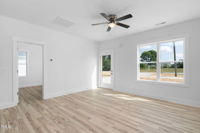 spare room with visible vents, a wealth of natural light, and light wood-style floors