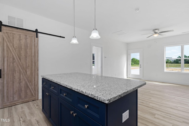 kitchen with light wood-type flooring, visible vents, a ceiling fan, and blue cabinets