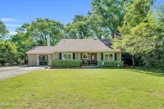 single story home featuring french doors, driveway, a chimney, and a front yard