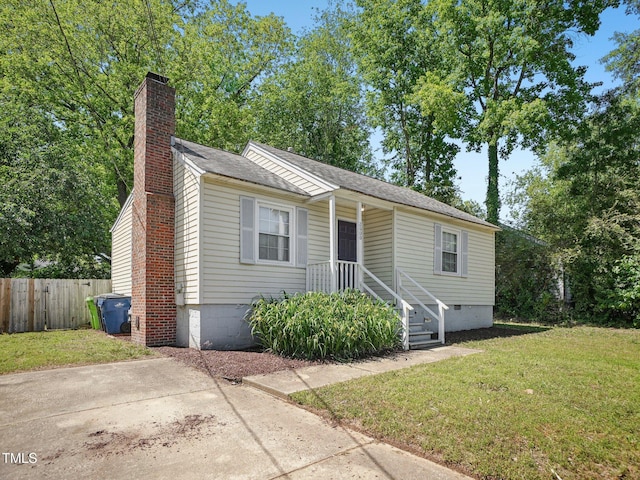 view of front of property featuring a front lawn, fence, a chimney, a shingled roof, and crawl space