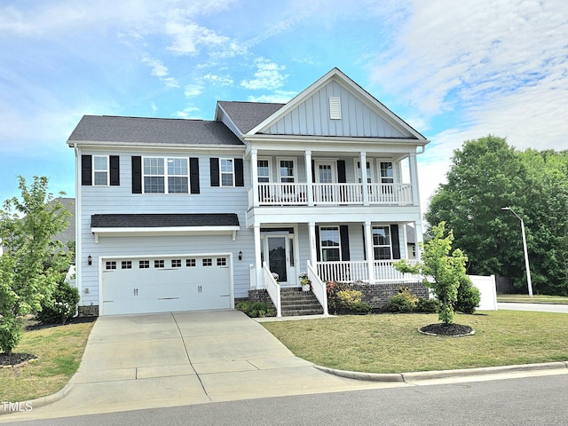 view of front of house with concrete driveway, an attached garage, board and batten siding, a porch, and a front yard