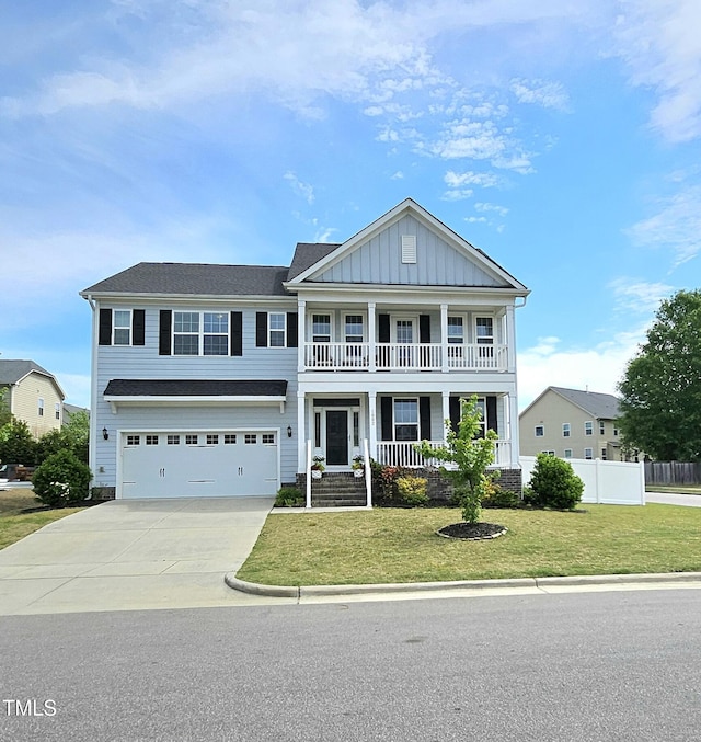 craftsman-style house with concrete driveway, an attached garage, board and batten siding, a porch, and a front yard