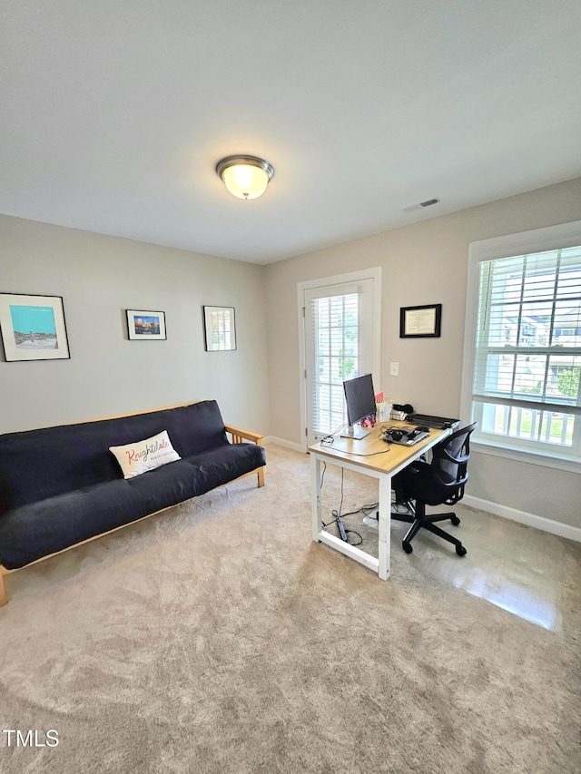 office space featuring baseboards, visible vents, and carpet