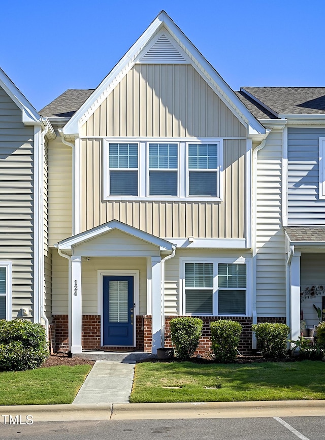 124 Shale Creek Dr, Durham, NC 27703 - multi unit property featuring board and batten siding, brick siding, roof with shingles, and a front yard