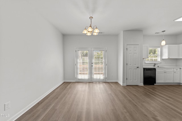 620 Hanska Way, Raleigh, NC 27610 - unfurnished dining area featuring light wood-style floors, a chandelier, baseboards, french doors, and a sink