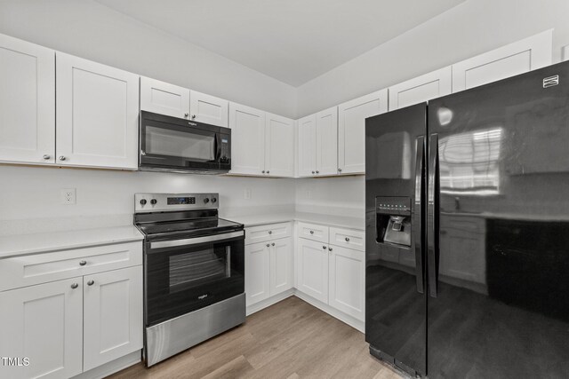 620 Hanska Way, Raleigh, NC 27610 - kitchen featuring black appliances, light countertops, light wood finished floors, and white cabinetry