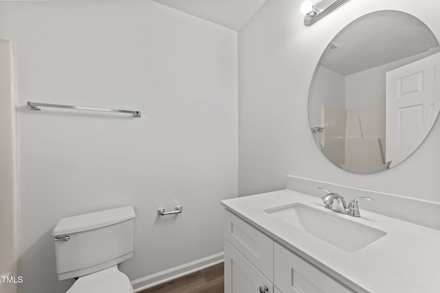 620 Hanska Way, Raleigh, NC 27610 - bathroom featuring toilet, vanity, wood finished floors, and baseboards