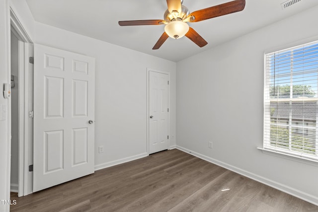 620 Hanska Way, Raleigh, NC 27610 - unfurnished bedroom with multiple windows, wood finished floors, and baseboards